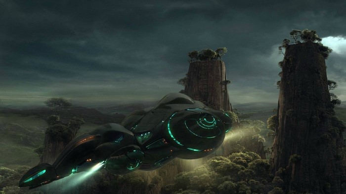 Alien spaceship flying over a mountainous landscape