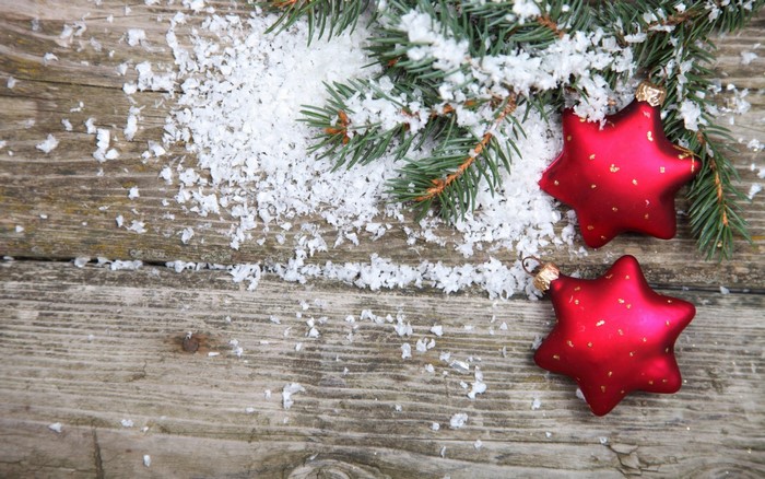 Christmas ornaments and pine branches on wood