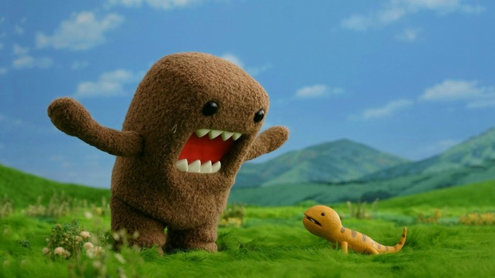Domo and a small creature in a grassy field
