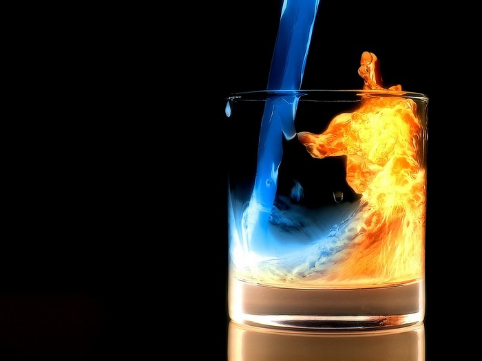Blue liquid and fire in a glass