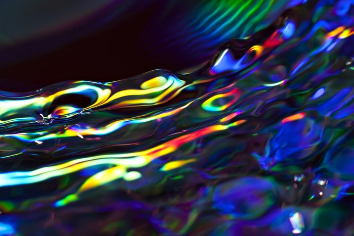 Abstract close-up of colorful light on water surface