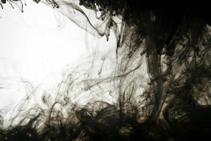 Black ink dissolving in water