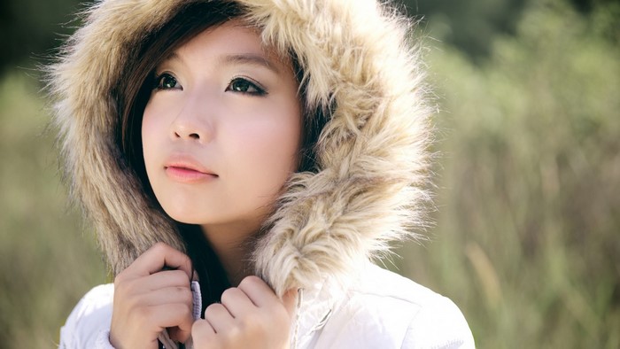 Asian woman wearing a fur-lined hood