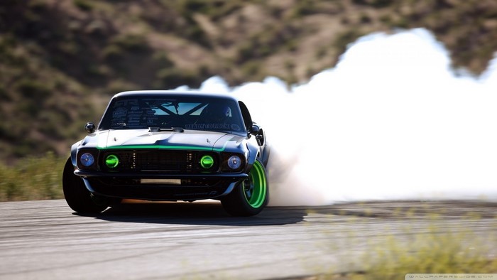 Black Ford Mustang drifting with smoke