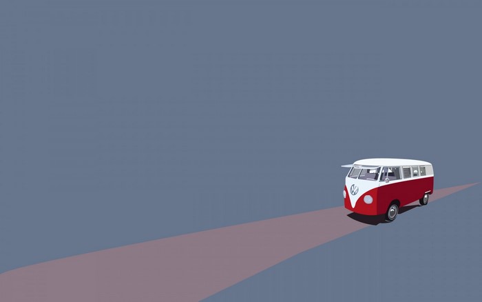 Red and white VW bus on a road