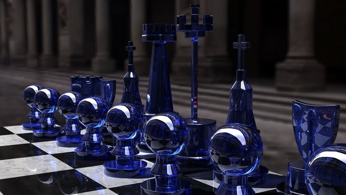 Blue glass chess set on a chessboard