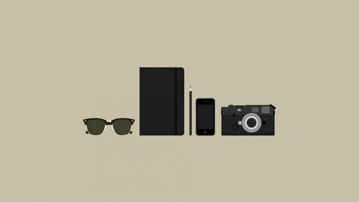 Minimalist flat lay of sunglasses, notebook, phone, and camera