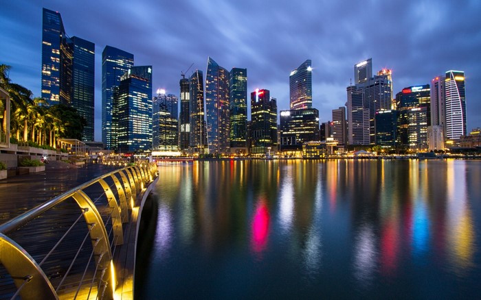Singapore skyline at night with reflections in the water