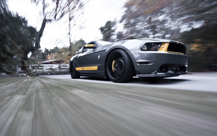 Silver Muscle Car in Motion with Black and Yellow Accents