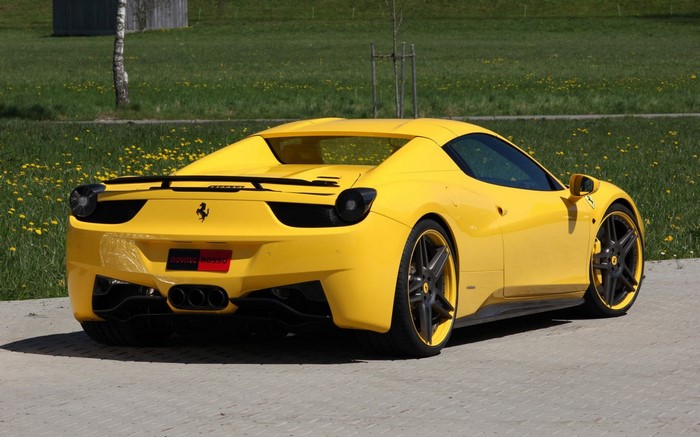 Yellow Ferrari 458 Italia parked on pavement