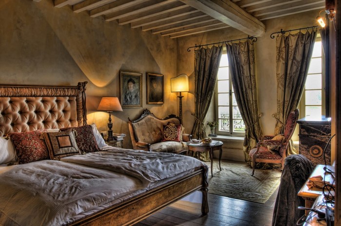 Luxurious bedroom with antique furniture and large windows