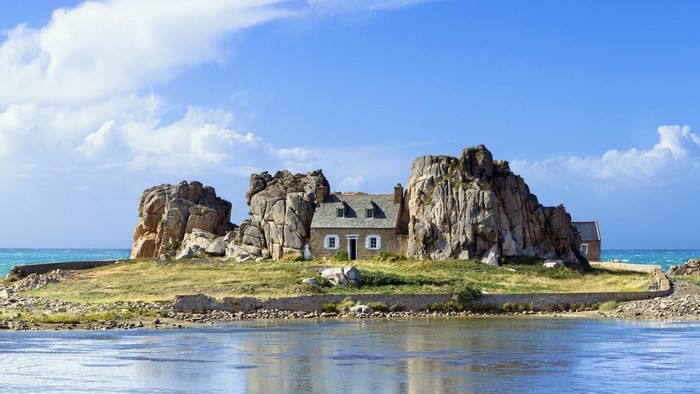 House on a rocky island in the sea