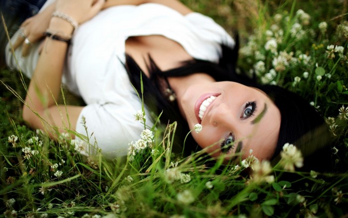 Smiling Woman Lying in Green Grass