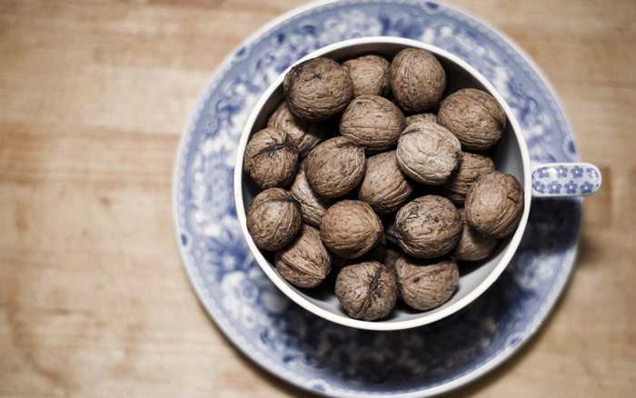 Walnuts in a cup on a saucer