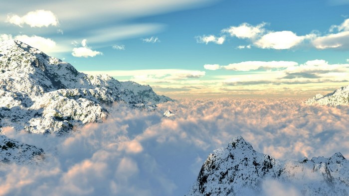 Snow-capped mountains above clouds at sunrise
