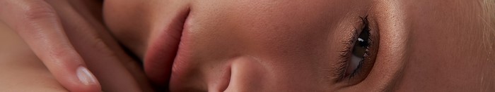 Close up of a woman's face with hand