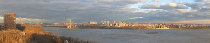 Panorama of New York City skyline across the river at dusk