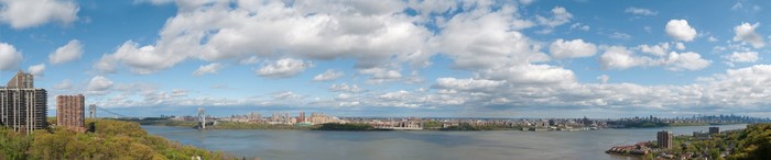 Panoramic view of New York City skyline across a bay