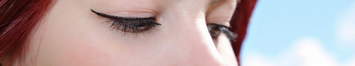Close up of a woman's eye with red hair