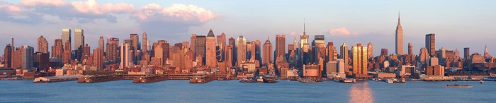 New York City skyline at dusk with boats on the water