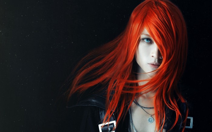 Woman with long red hair and blue eyes