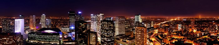 Panoramic night cityscape of Paris with illuminated skyscrapers