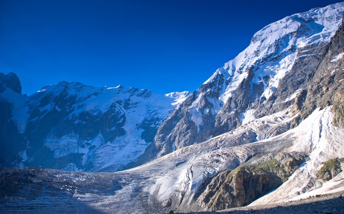 Snow-capped mountains and glaciers under a clear blue sky