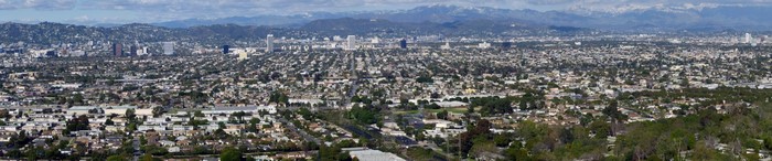 Panoramic view of Los Angeles cityscape with mountains