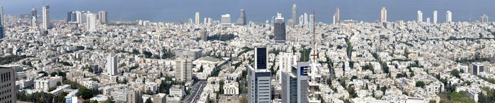 Panoramic cityscape of a dense metropolis with numerous skyscrapers.