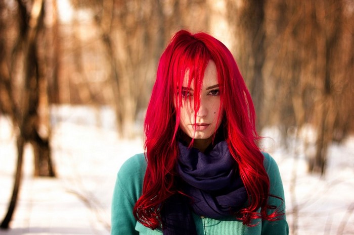 Woman with bright red hair and blue scarf