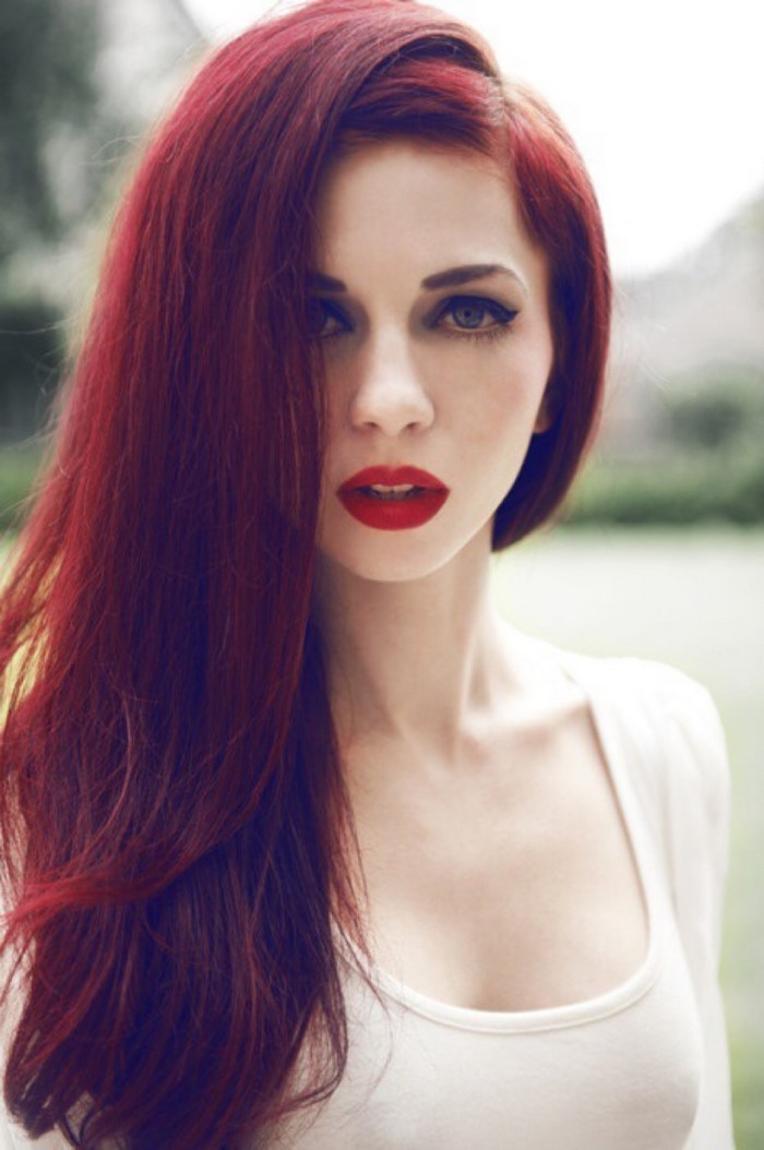 Woman with long red hair and red lipstick