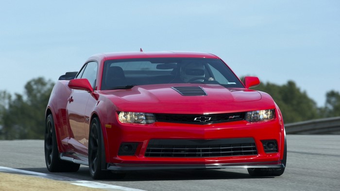 Red Chevrolet Camaro ZL1 driving on a track