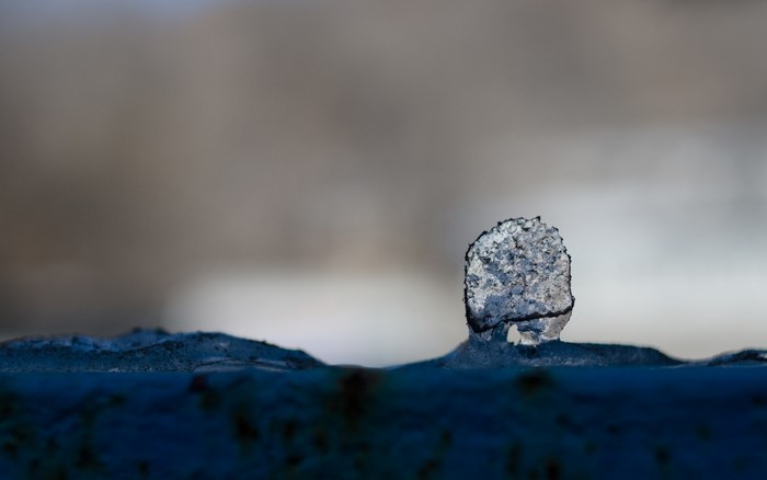 Close up of ice formation on a blue surface