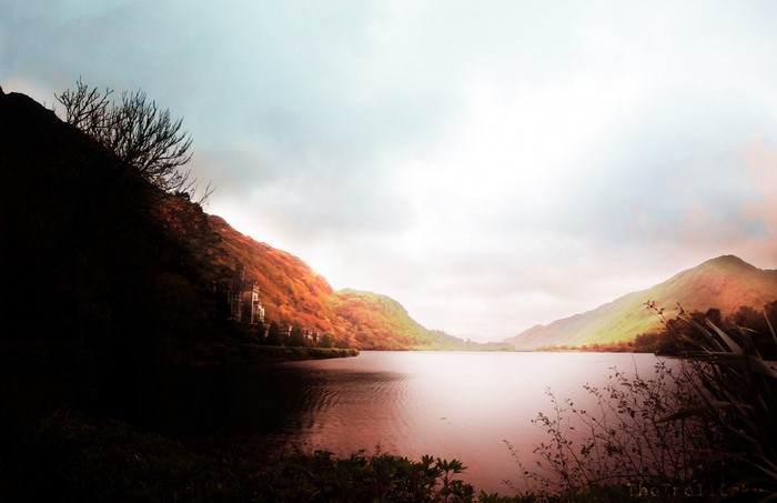 Castle on a hill overlooking a lake at sunset