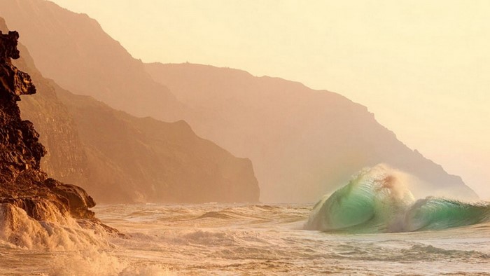 Coastal cliffs and ocean waves at sunrise