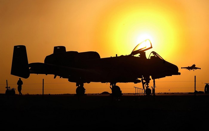 Silhouette of A-10 Thunderbolt II aircraft at sunset