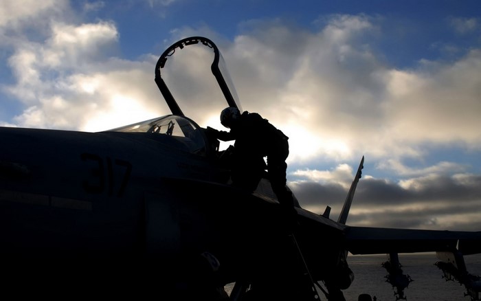Pilot climbing into a McDonnell Douglas F/A-18 Hornet