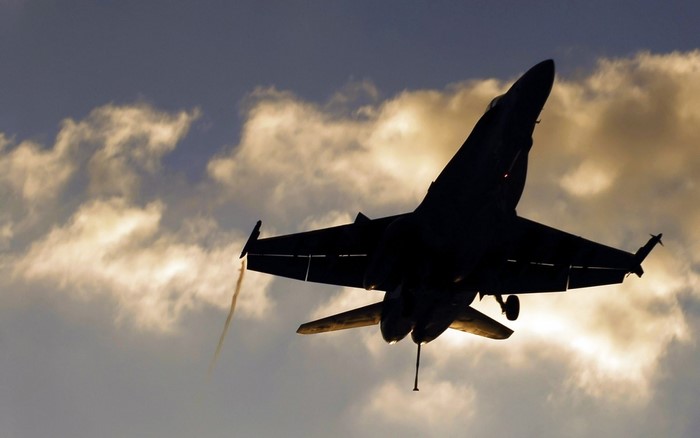 Silhouette of a fighter jet taking off