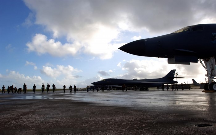 Military aircraft on tarmac with personnel