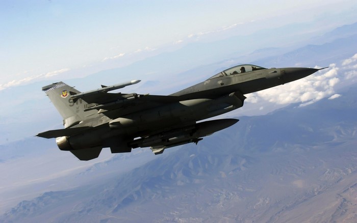 F-16 Fighting Falcon in flight over mountains