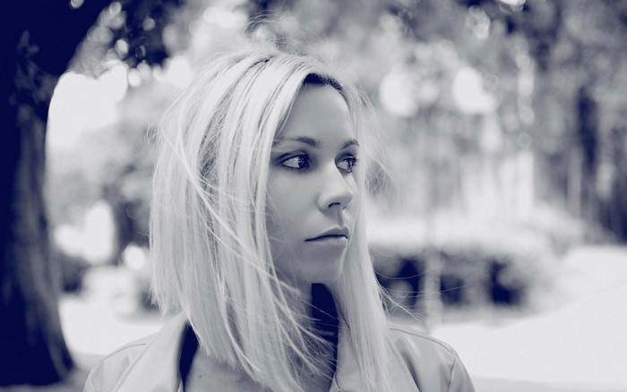 Monochrome portrait of a woman with blonde hair outdoors
