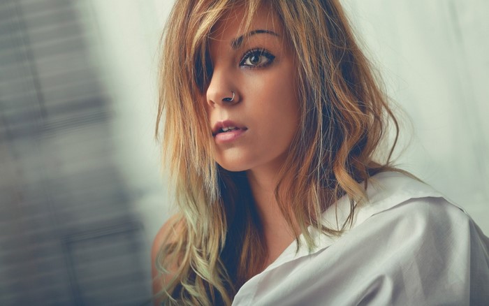 Woman with blonde hair and nose piercing