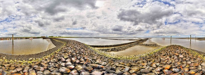 Coastal landscape with breakwaters and boats