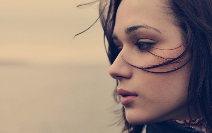 Close up portrait of a young woman with hair in her face