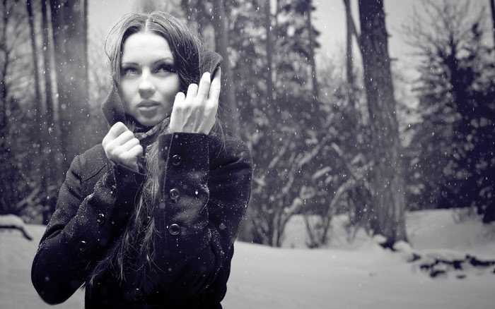 Woman in a black coat in the snow