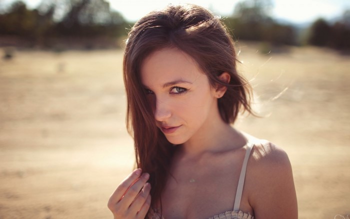 Woman with brown hair in a dress outdoors