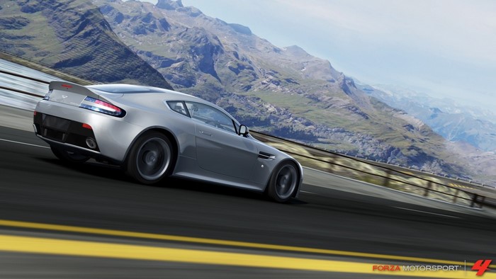 Silver Aston Martin V8 Vantage driving on a mountain road in Forza Motorsport 4