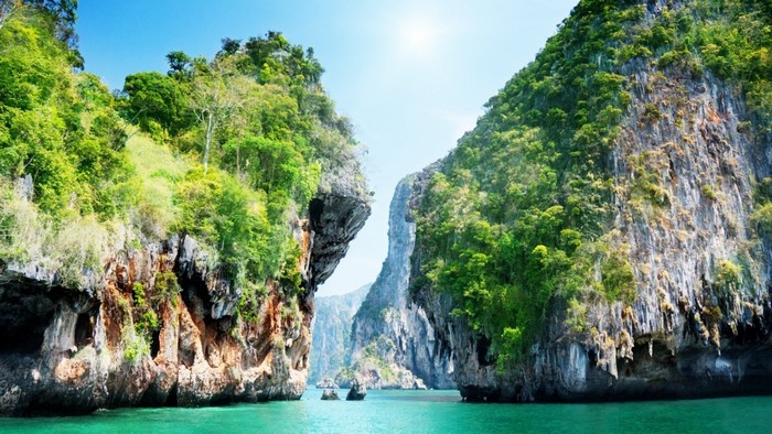Limestone cliffs covered in green vegetation in a tropical bay