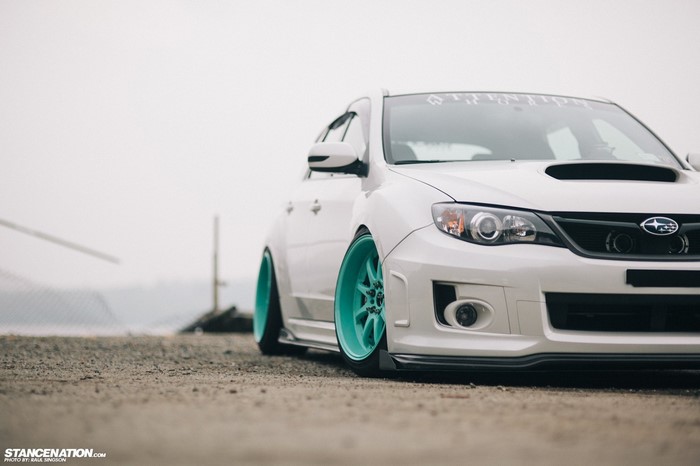 White Subaru Impreza WRX STi with teal wheels