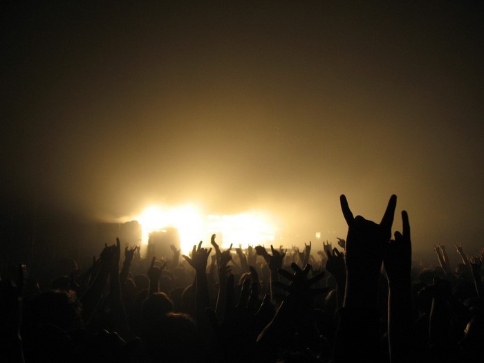 Crowd at a concert with hands raised